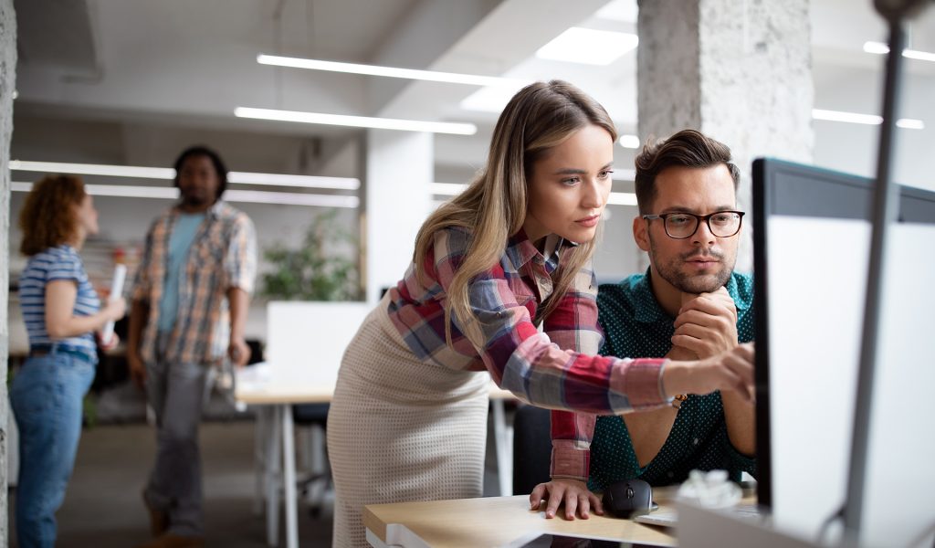 Group of business people, designers and software developers working as a team in office